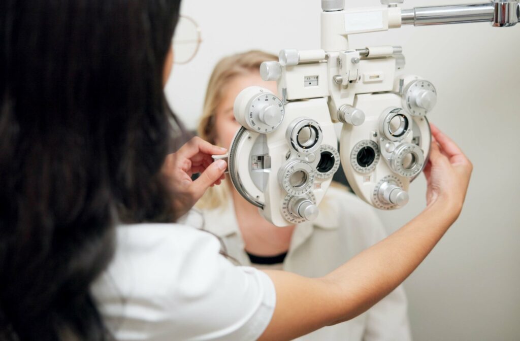 An optometrist gets the technology set up to give a patient an eyeglass prescription